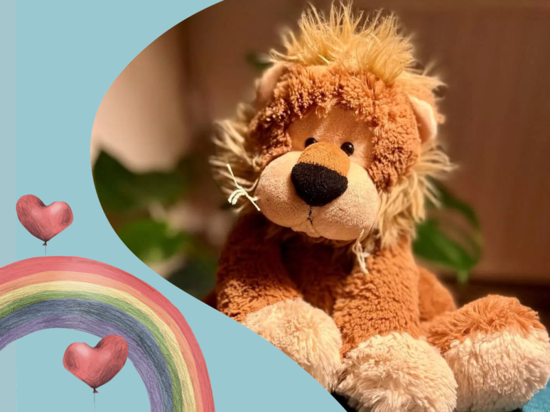 Løvebamse med regnbue og hjerteballon-grafik